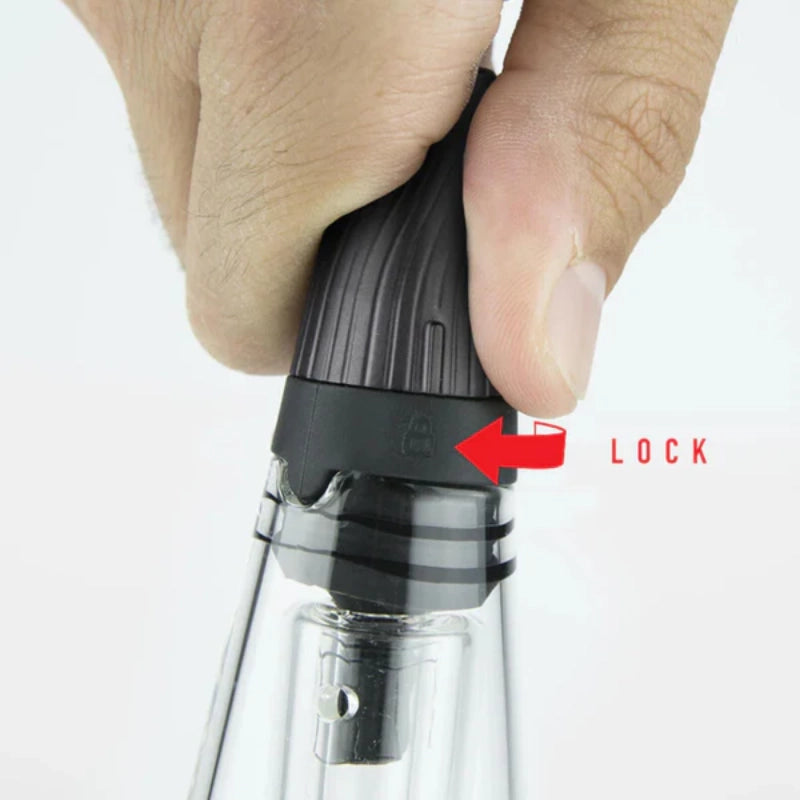 Hand gripping the lock mechanism on the Puffco Peak Pro Travel Glass, showcasing its secure water chamber.
